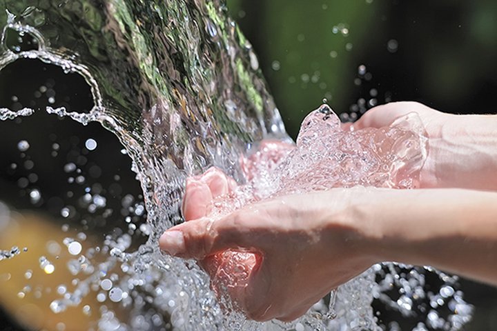 Woman's hands with water splash